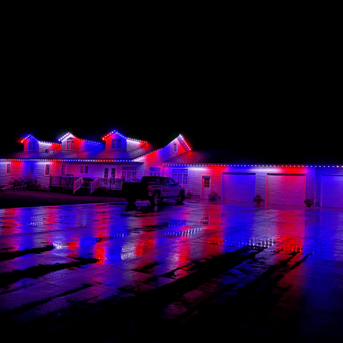 Home exterior illuminated with customizable Minleon permanent LED lighting, showcasing dynamic color patterns.